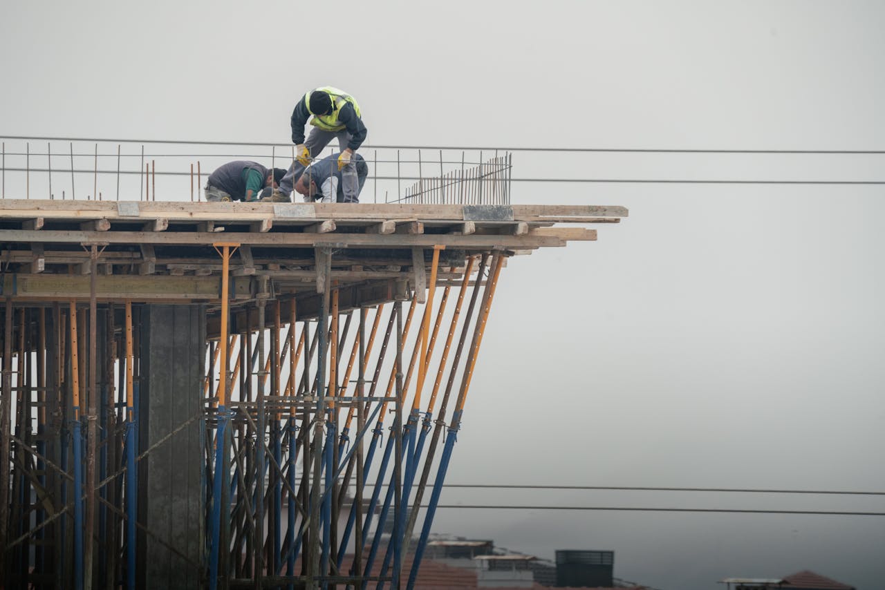 Services Workers on a high-rise building construction site in Denizli, Türkiye, showcasing teamwork and safety.